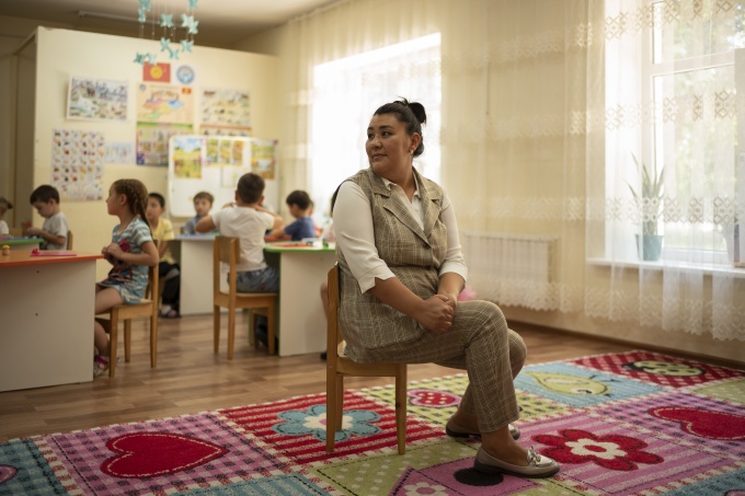 Aidana Azatovna, teacher at Ak-Bulak Kindergarten, looks towards her class on Monday, June 20, 2022, in Grozd, Kyrgyz Republic. Credit: GPE/Maxime Fossat